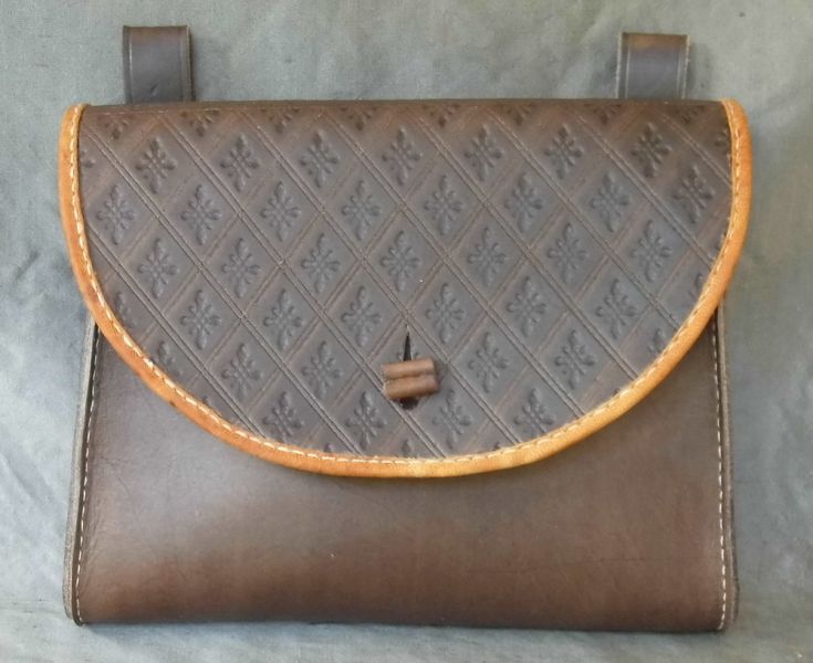 16th - 17th century belt wallet with a  tooled round front and side gussets